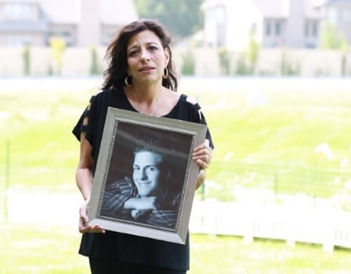 A Woman Holding a Picture of Her Loved One on International Overdose Awareness Day