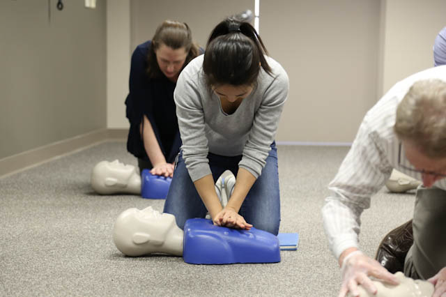 Participants of first aid training practing CPR