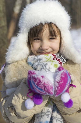 Child in Mittens Enjoying the Snow