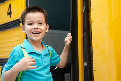 A Young Boy Boards a School Bus